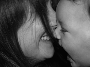 Black and white image of a mother and baby face to face